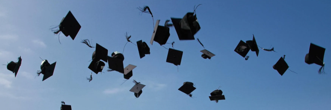 Graduation Caps in tossed in the air.
